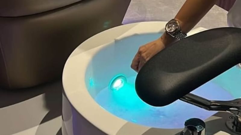 A person’s hand reaches into a spa foot bath at Warwick Hotels and Resorts