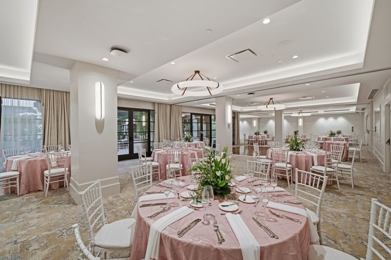Elegantly set banquet hall with round tables and pink tablecloths at El Prado Palo Alto.