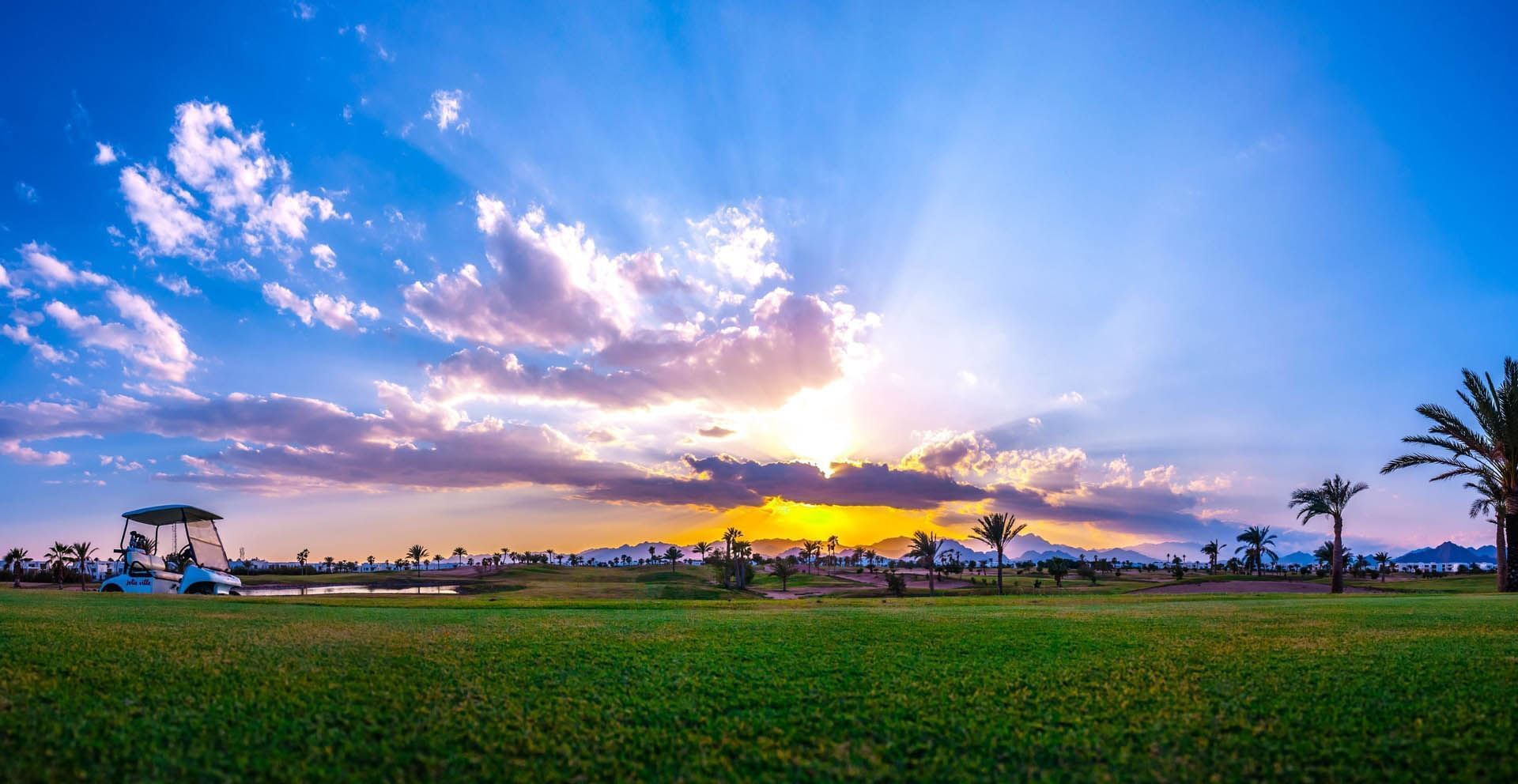 Sunset at Pickalbatros Golf Beach Resort, showcasing the best golf courses in Egypt with distant peaks under a vibrant sky