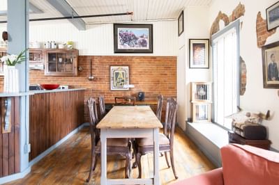 Kitchen area with wooden dining table in Apartment 405 at Retro Suites Hotel