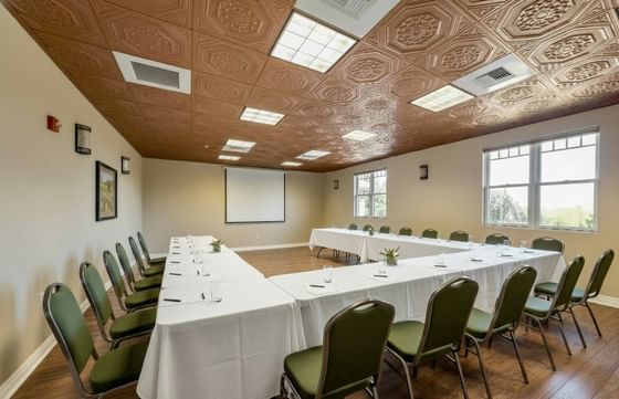 Conference room tables surrounded by green chairs at Oregon Garden Resort, a featured hotels in Silverton