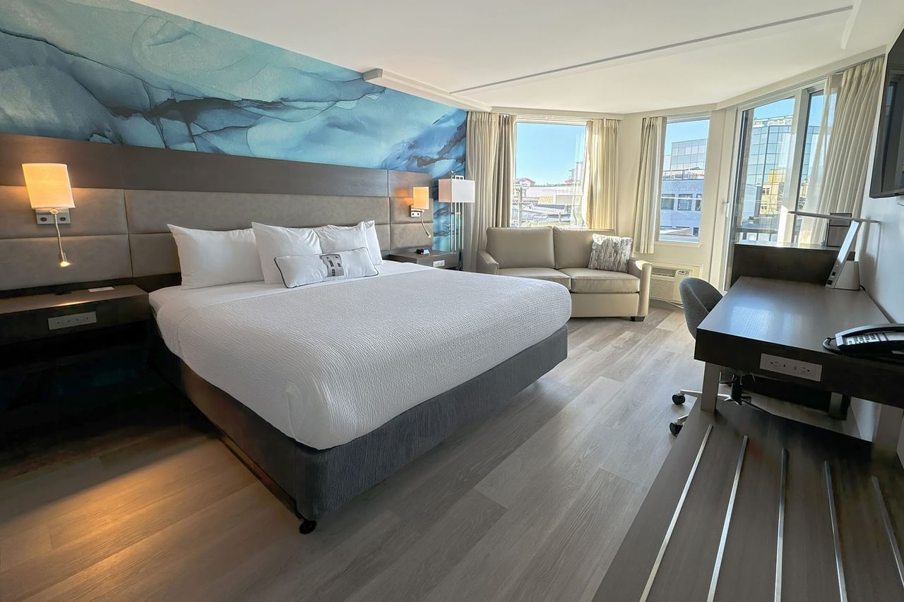 Accessible hotel guestroom with king bed, work desk and sofa