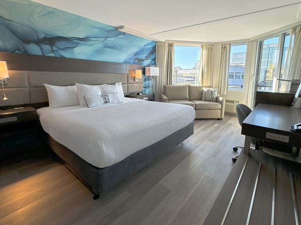 Accessible hotel guestroom with King bed, desk and sofa