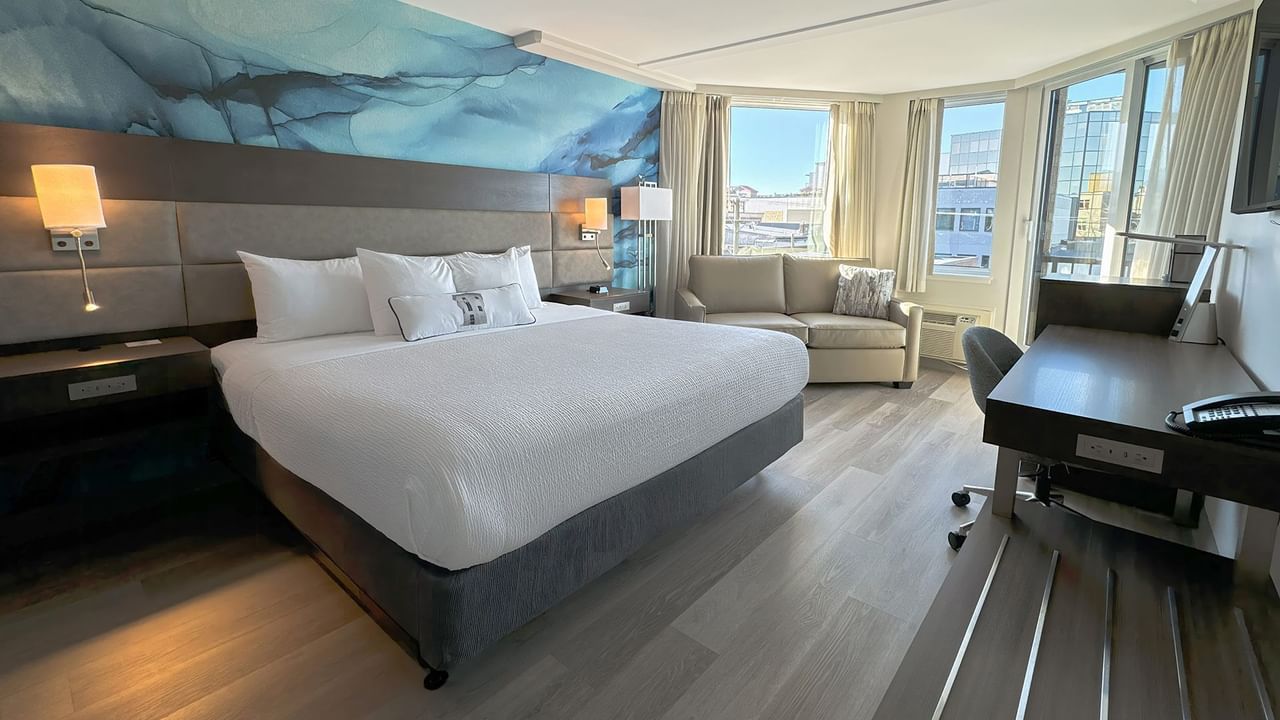 Accessible hotel guestroom with King bed, desk and sofa