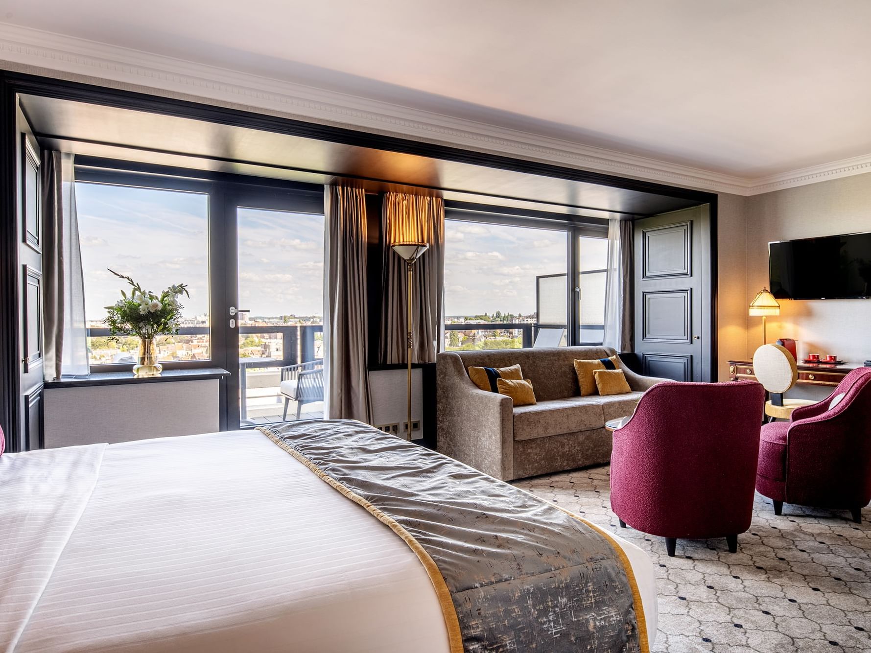 TV lounge area by the bed in Junior Suite with a city view at Hotel Barsey by Warwick - Brussels