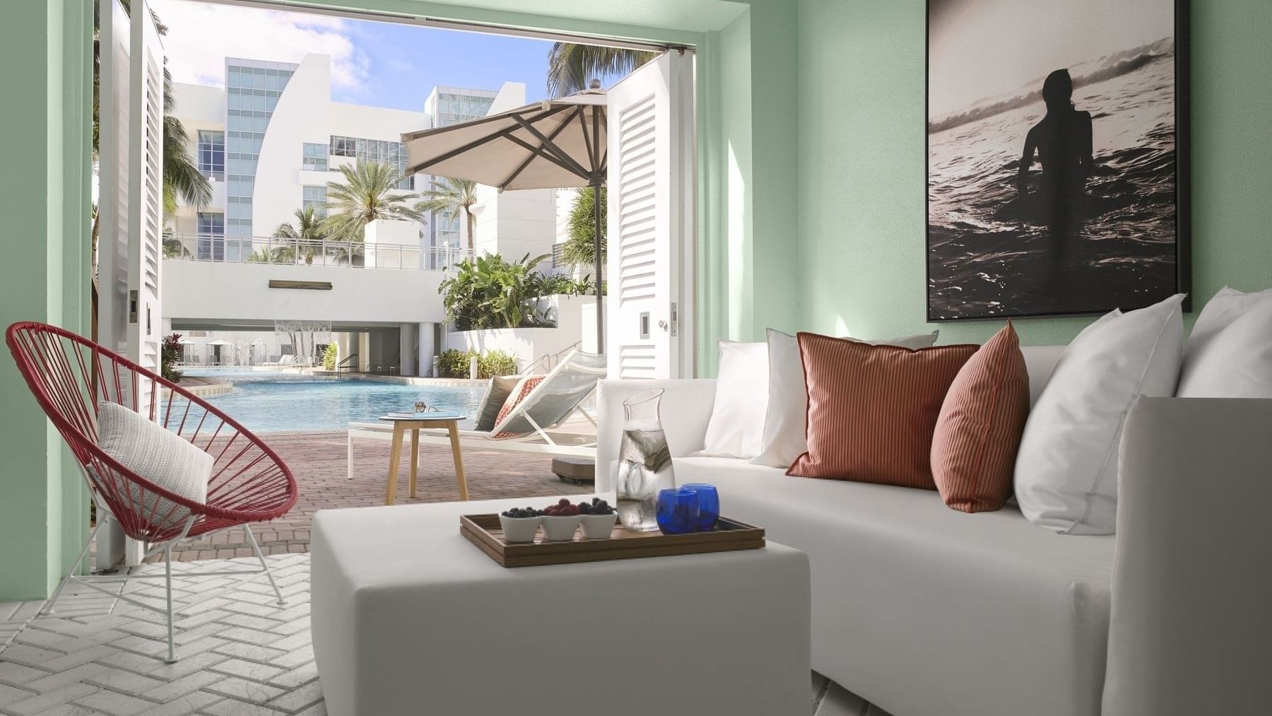 Lounge area with cozy sofa in Poolside Cabana at The Diplomat Resort