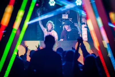 Crowd gathered by a DJ at The Morgan Resort Spa Village