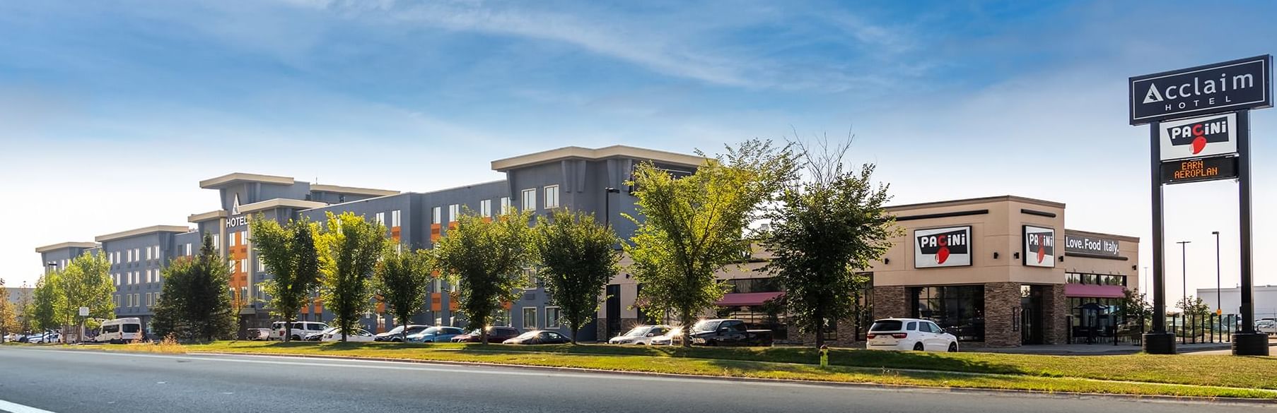 Panorama and distant view of Acclaim Hotel Calgary from across the street