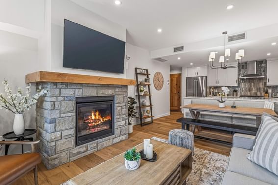 Modern living room with a fireplace, sofa and open kitchen at Spring Creek Vacation Homes Canmore