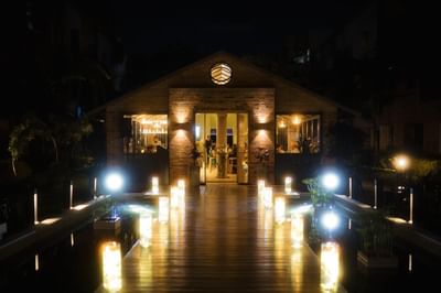 Manduka Restaurant's dining cabin at Habitel Prime Hotel with a wooden deck and cozy nighttime ambiance