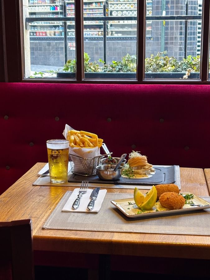 Delicious gourmet meal with fries and a cold beer served at Hotel Barsey by Warwick