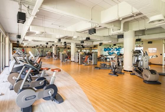 A well-equipped fitness center with polished wooden floors at Eastin Thana City Golf Resort Bangkok