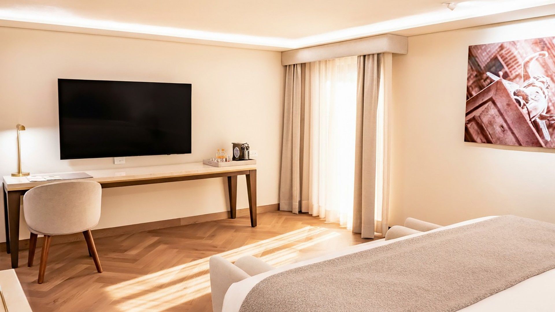 Two King Premium with a wall-mounted TV, wooden desk, and large light-colored curtains at Quinta Real Puebla