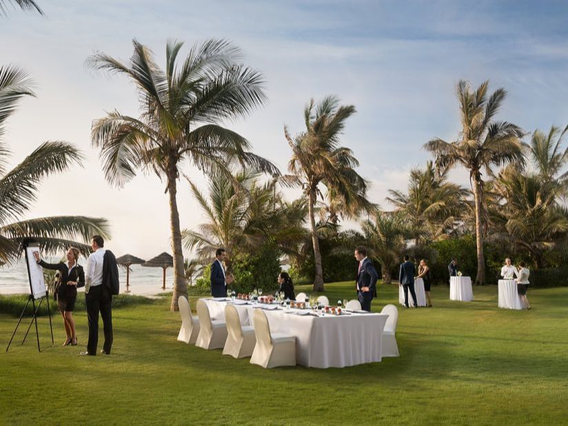 A group of people in the Palm lawn area at Ajman Hotel