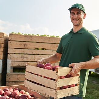 produce distrobution employee holding a basket of fruits