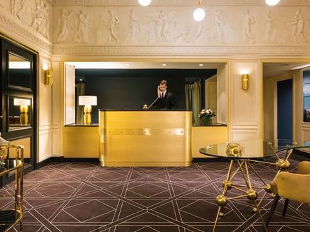 A male receptionist at the front desk at Warwick Hotel Barsey