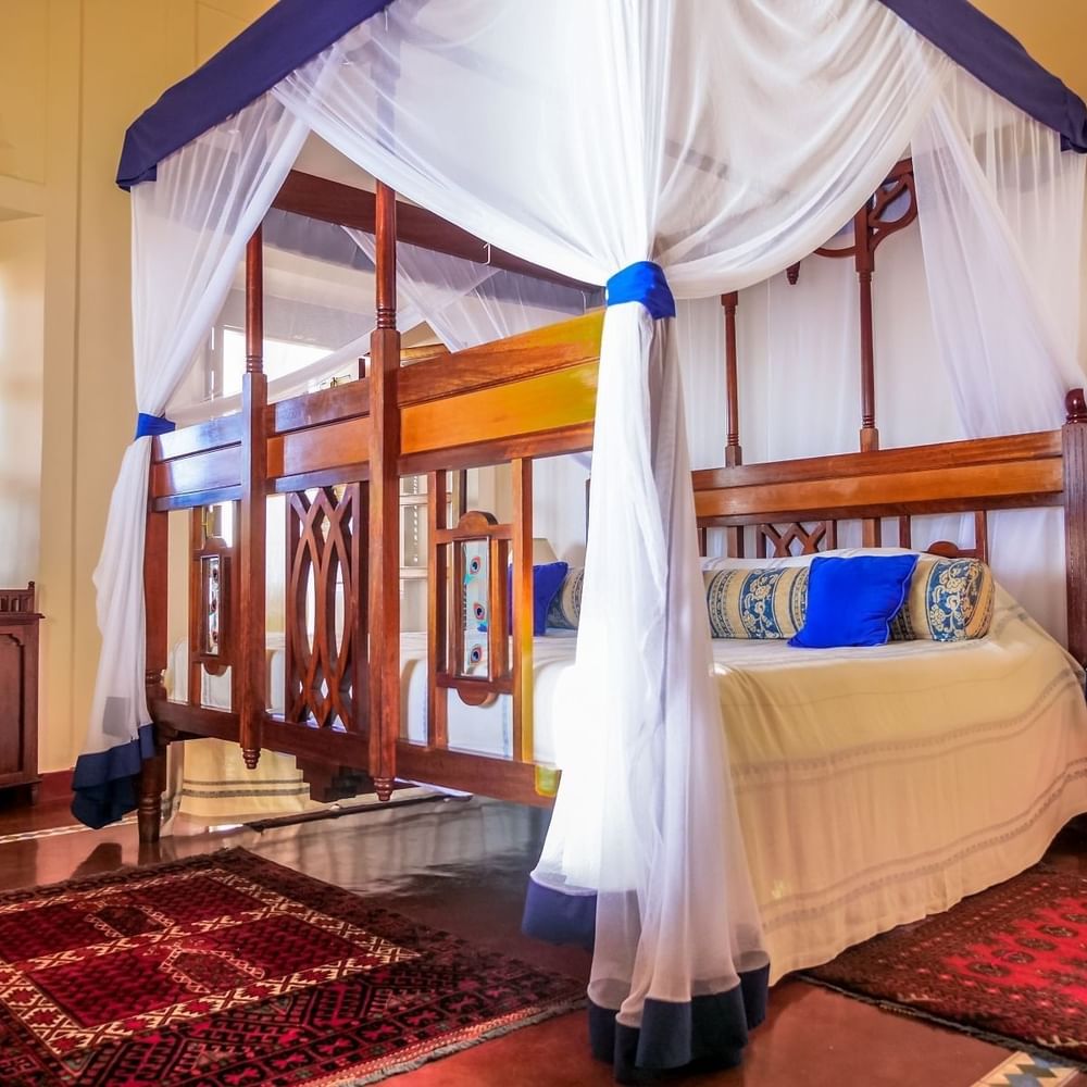 Elegantly decorated Prime King Room with a canopy bed at Zanzibar Serena Hotel in Zanzibar.