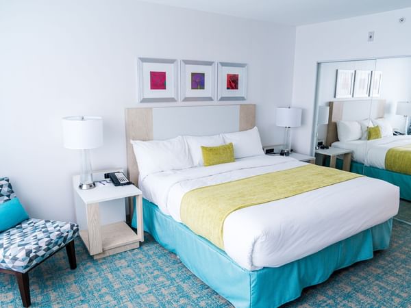 Bed in hotel room with green and blue colors