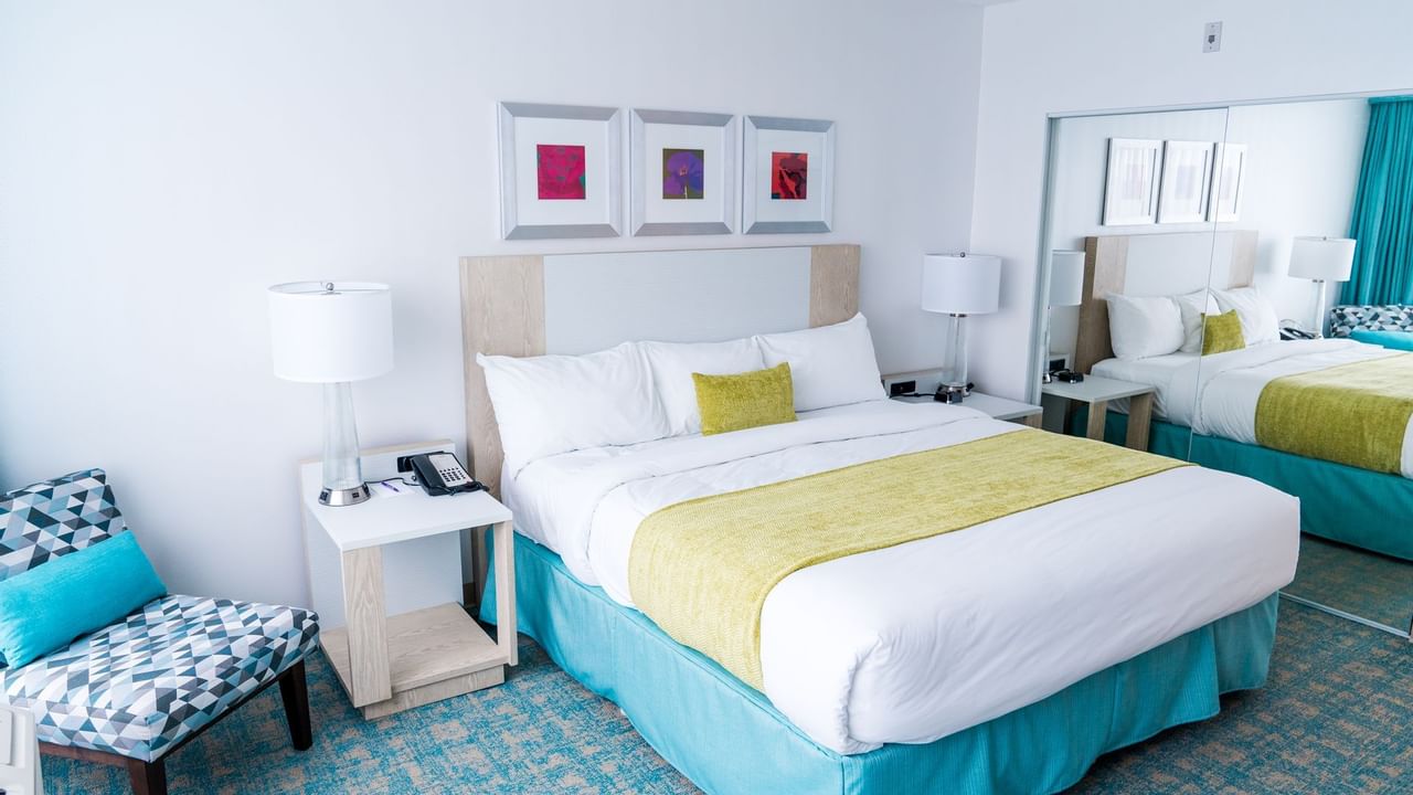 Bed in hotel room with green and blue colors