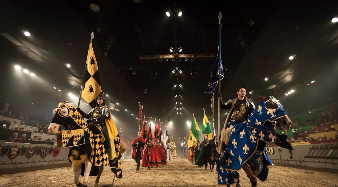 A medieval-themed dining event with horses and people in costume