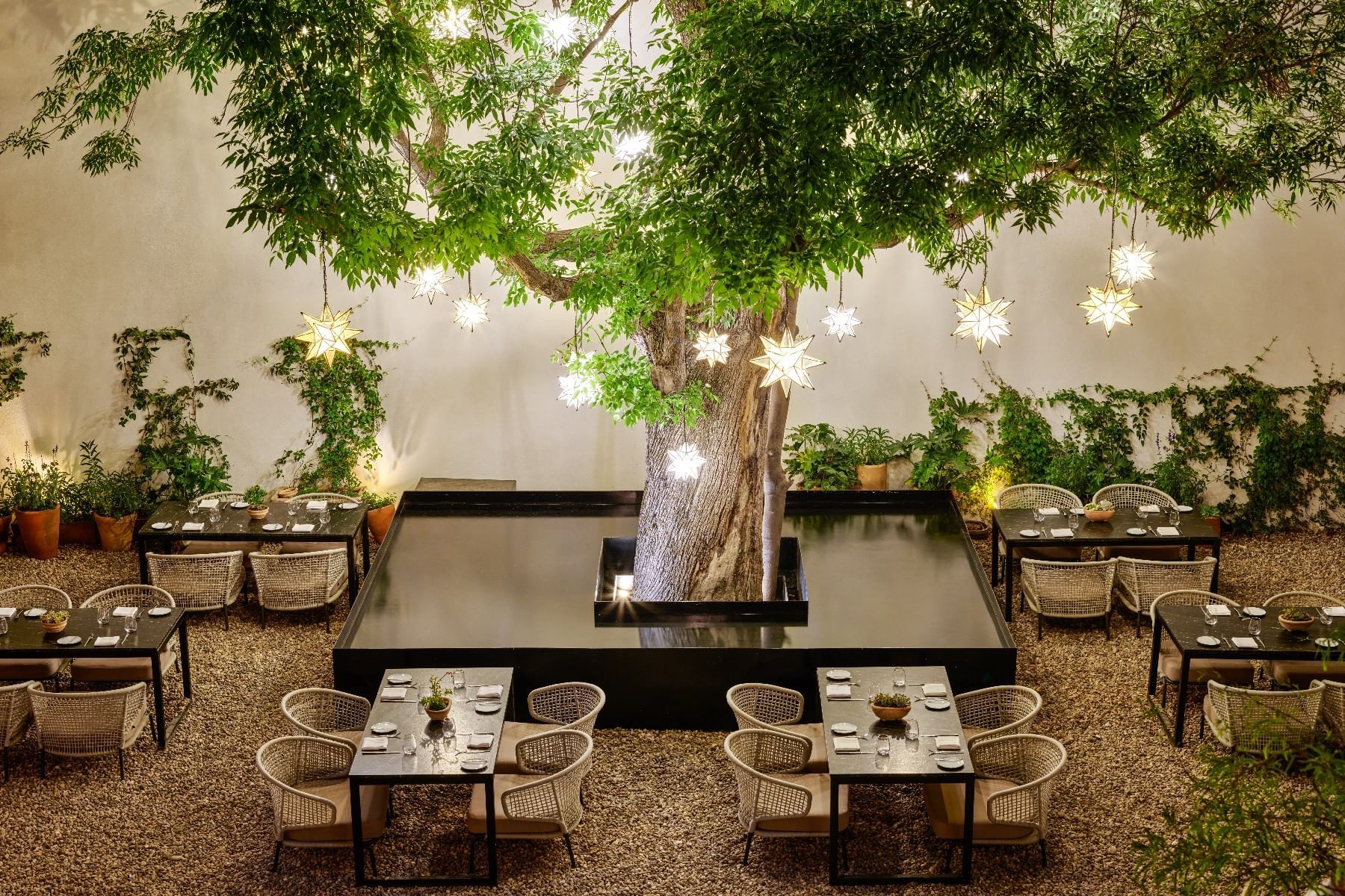 Charming outdoor dining area arranged in Patio Del Árbol at Live Aqua San Miguel de Allende