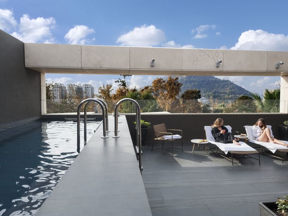 Two women enjoying near Rooftop Pool at Hotel Ismael