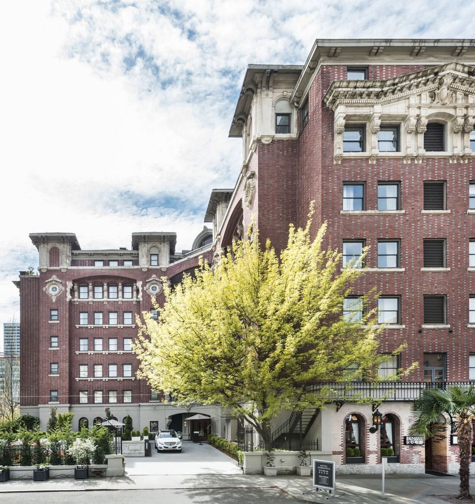 Exterior view of Hotel Sorrento with lush trees in the foreground