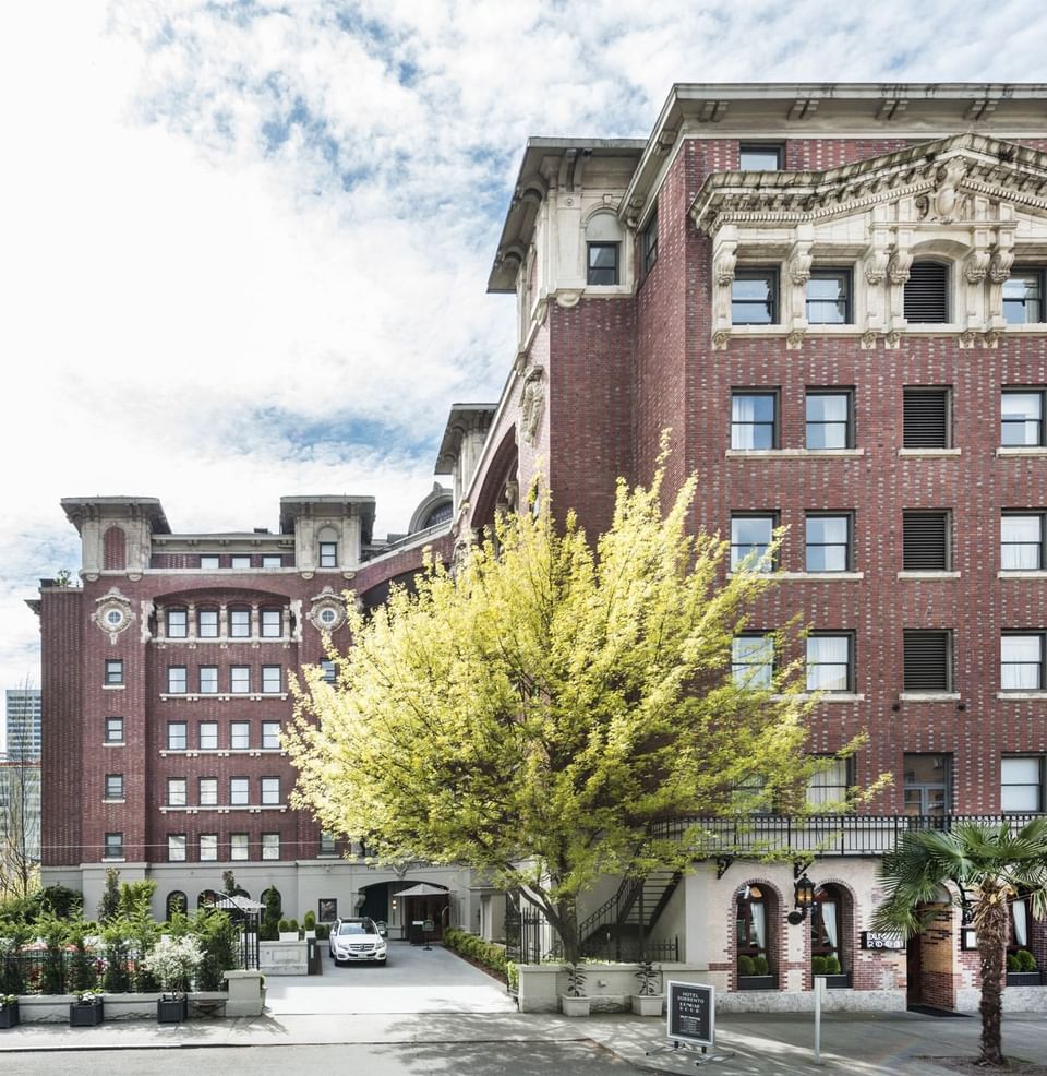 Exterior view of Hotel Sorrento with lush trees in the foreground