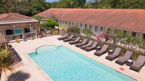 Outdoor pool at Hotel Le Lodge of The Originals Hotels