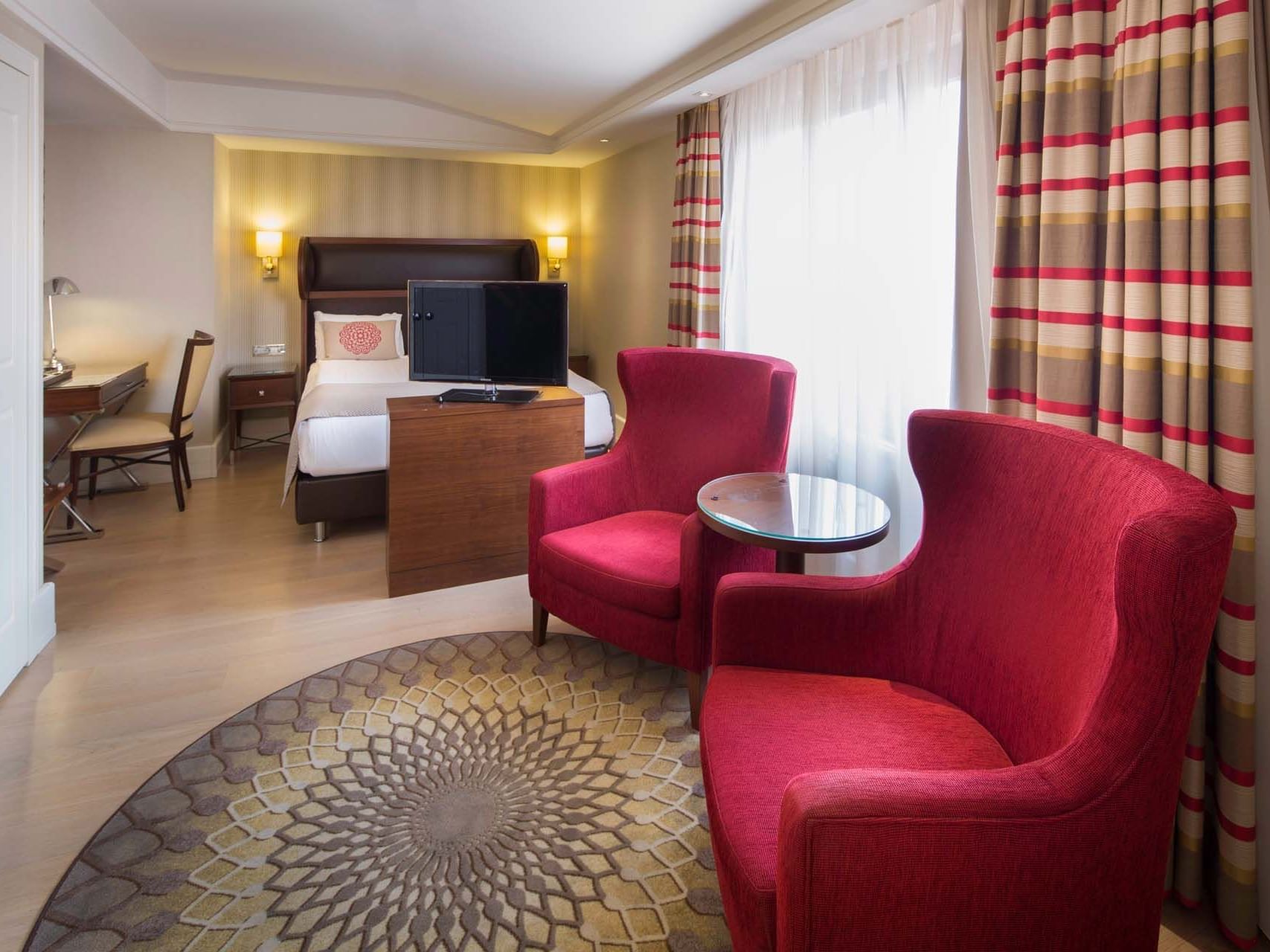 Bed room and lounge area in the Superior Room at Titanic Comfort Sisli
