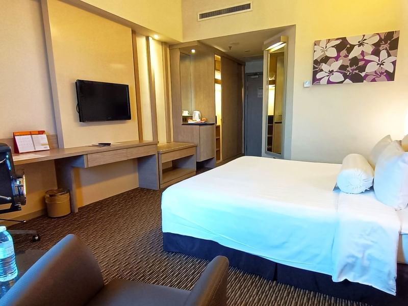 Premier King Room with a large bed and a TV mounted over a desk at Sunway Hotel Seberang Jaya