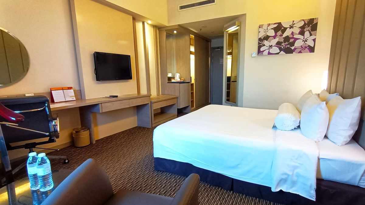 Premier King Room with a large bed and a TV mounted over a desk at Sunway Hotel Seberang Jaya