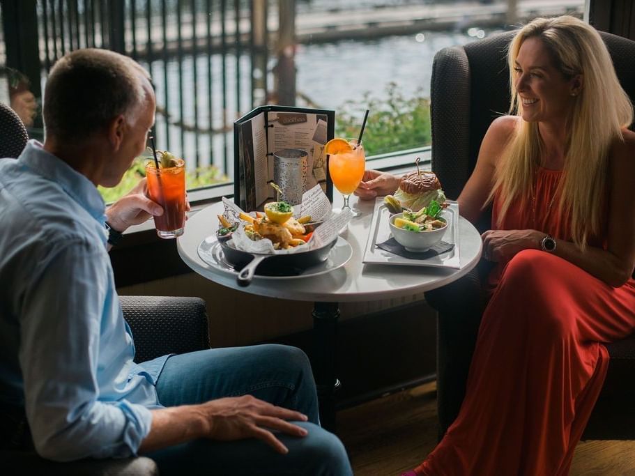 Happy couple enjoying a meal in a restaurant at Hotel Eldorado
