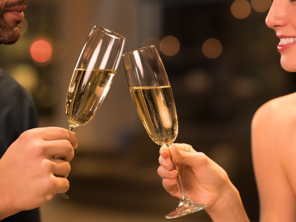 A couple is having a Romantic Sparkling Wine at Monte Carlo Inn Barrie Suites