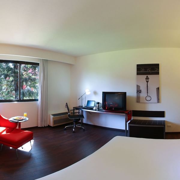 King bed with furniture in Superior Room at Fiesta Inn