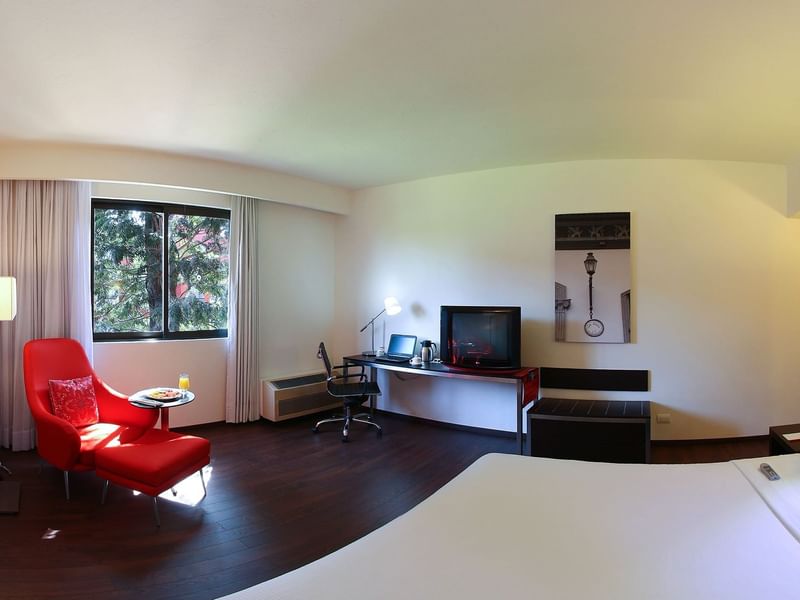 King bed with furniture in Superior Room at Fiesta Inn