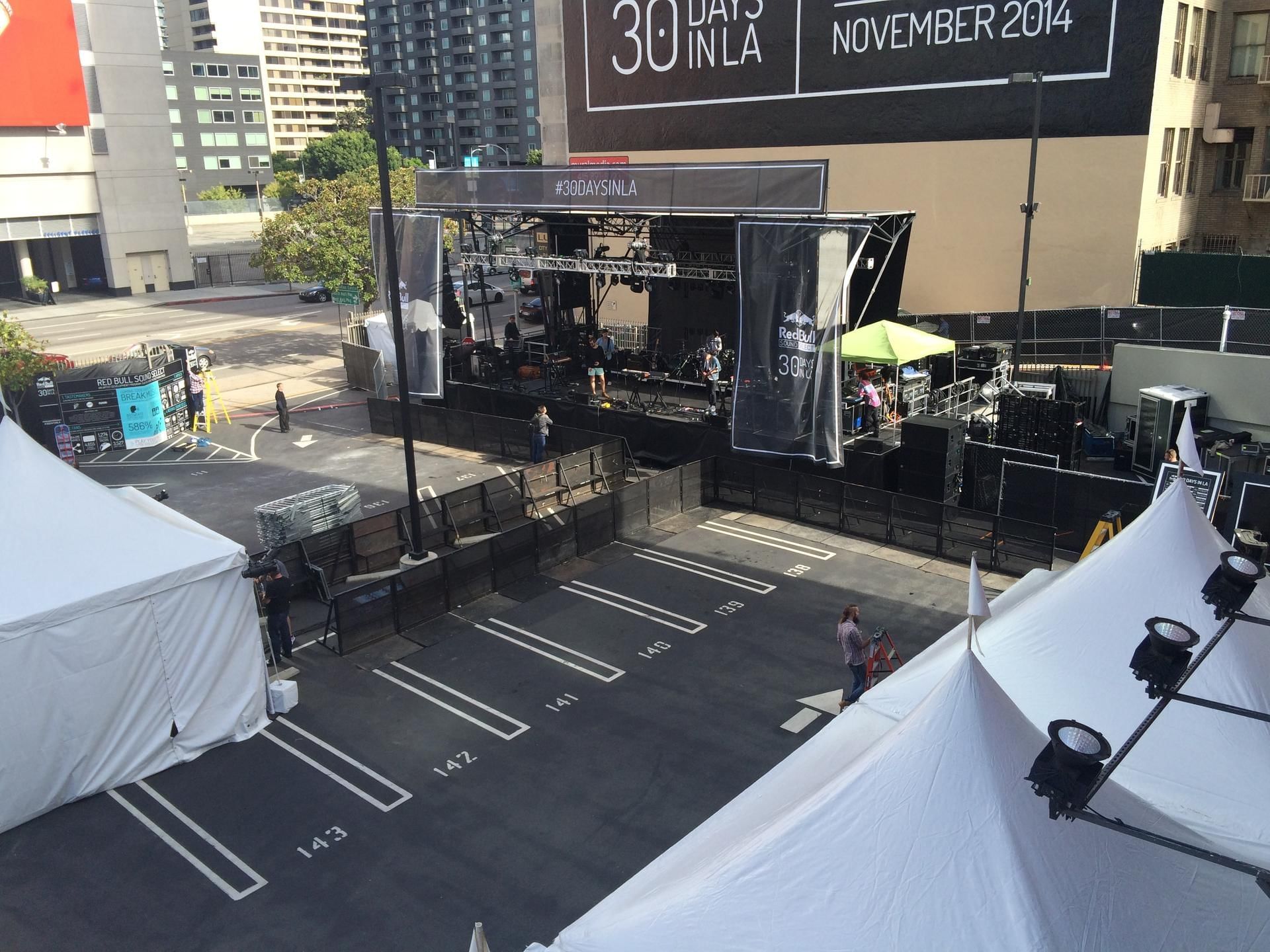 An outdoor event space with a stage and tents