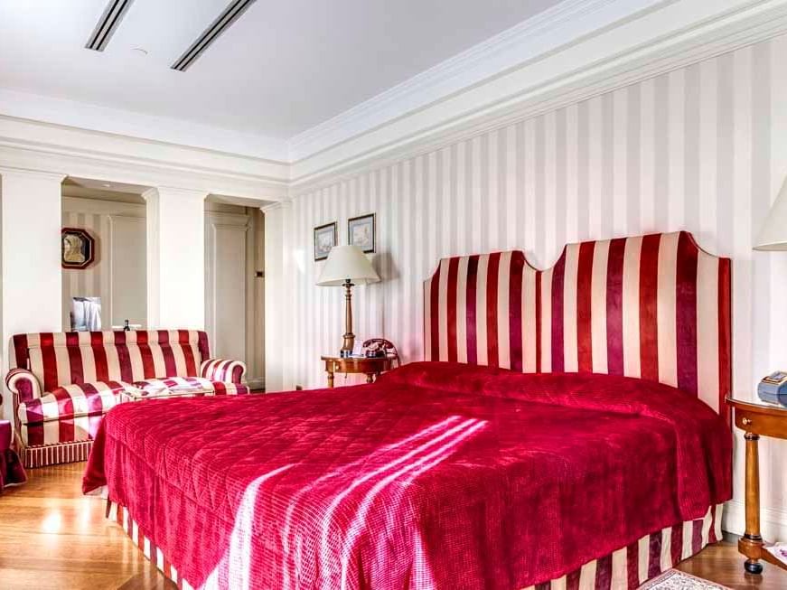 Comfy bed with red blanket in Suites at Bettoja Hotel Mediterraneo