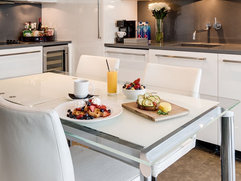 A dining table set with breakfast in a modern kitchenette