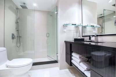 The Bathroom with a glass shower at Granville Island Hotel