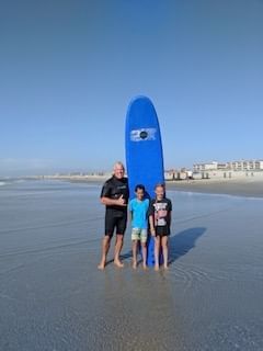 Lifeguard & two kids with a surf board near our hotel in Wildwood Crest NJ