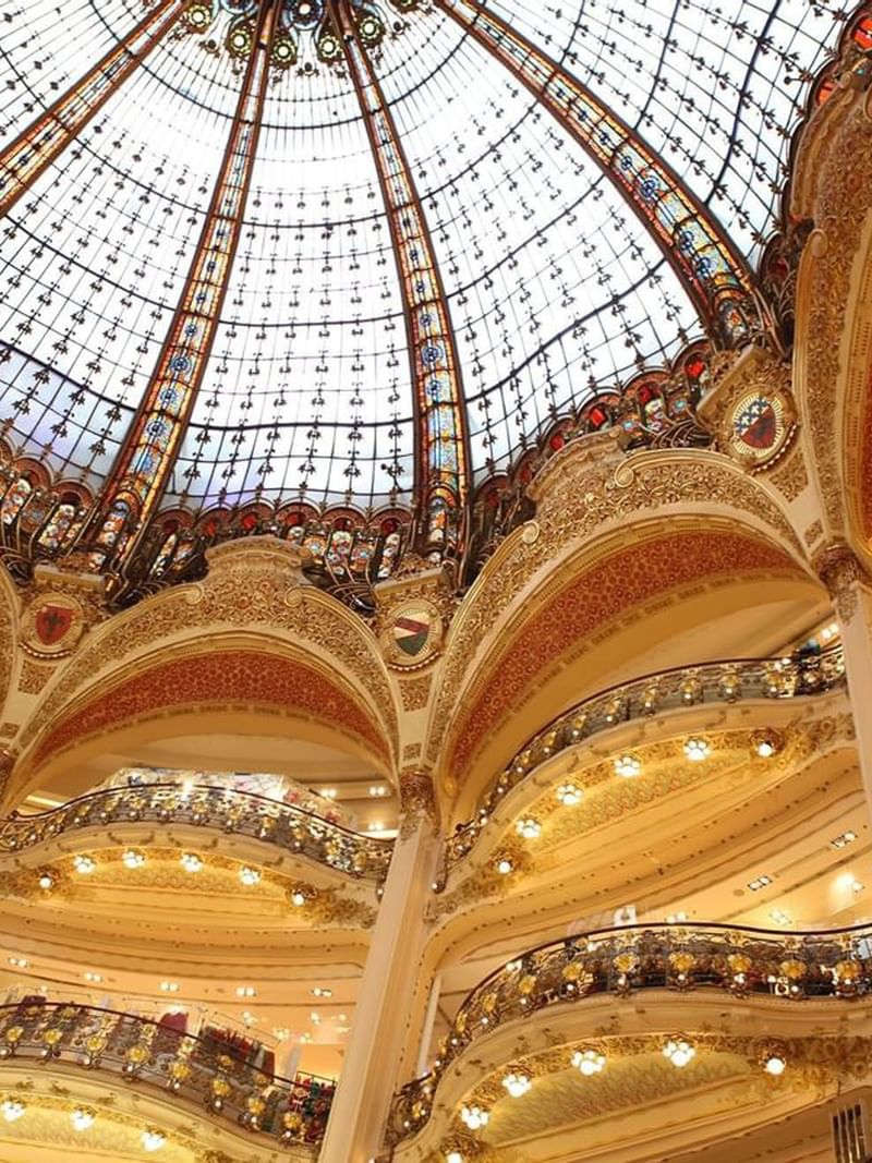 Galeries Lafayette by gold balconies under intricate architectural details near Warwick Paris Champs Elysées