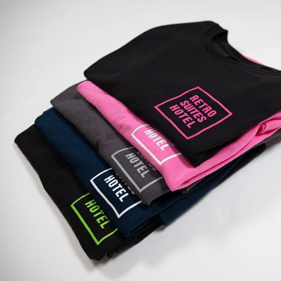 Folded t-shirts with Retro Suites logo at Retro Suite Hotel