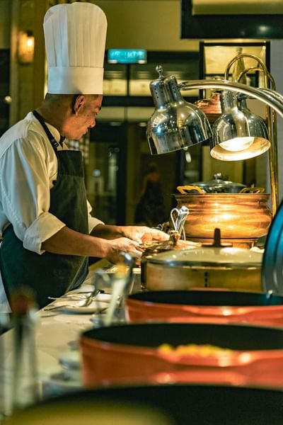 Chef preparing meals in the kitchen of Pelangi Beach Resort