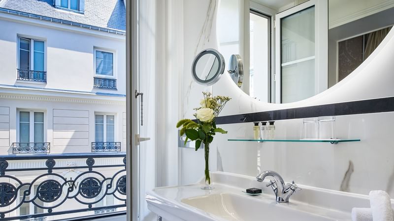 Deluxe Belle-Époque Suite bathroom with mirrored sink and windows overlooking the city at Hôtel Westminster - Paris
