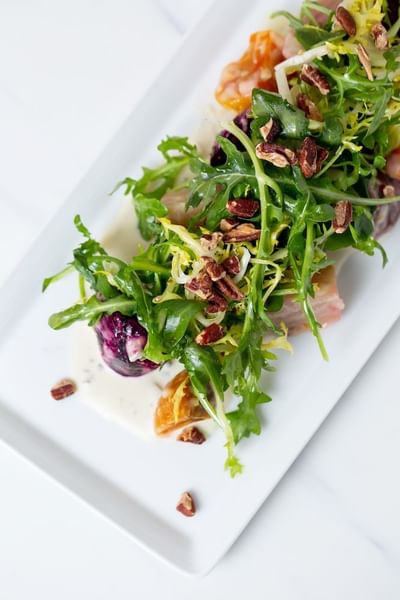 Close-up of a salad served on a white plate at Stein Eriksen Residences