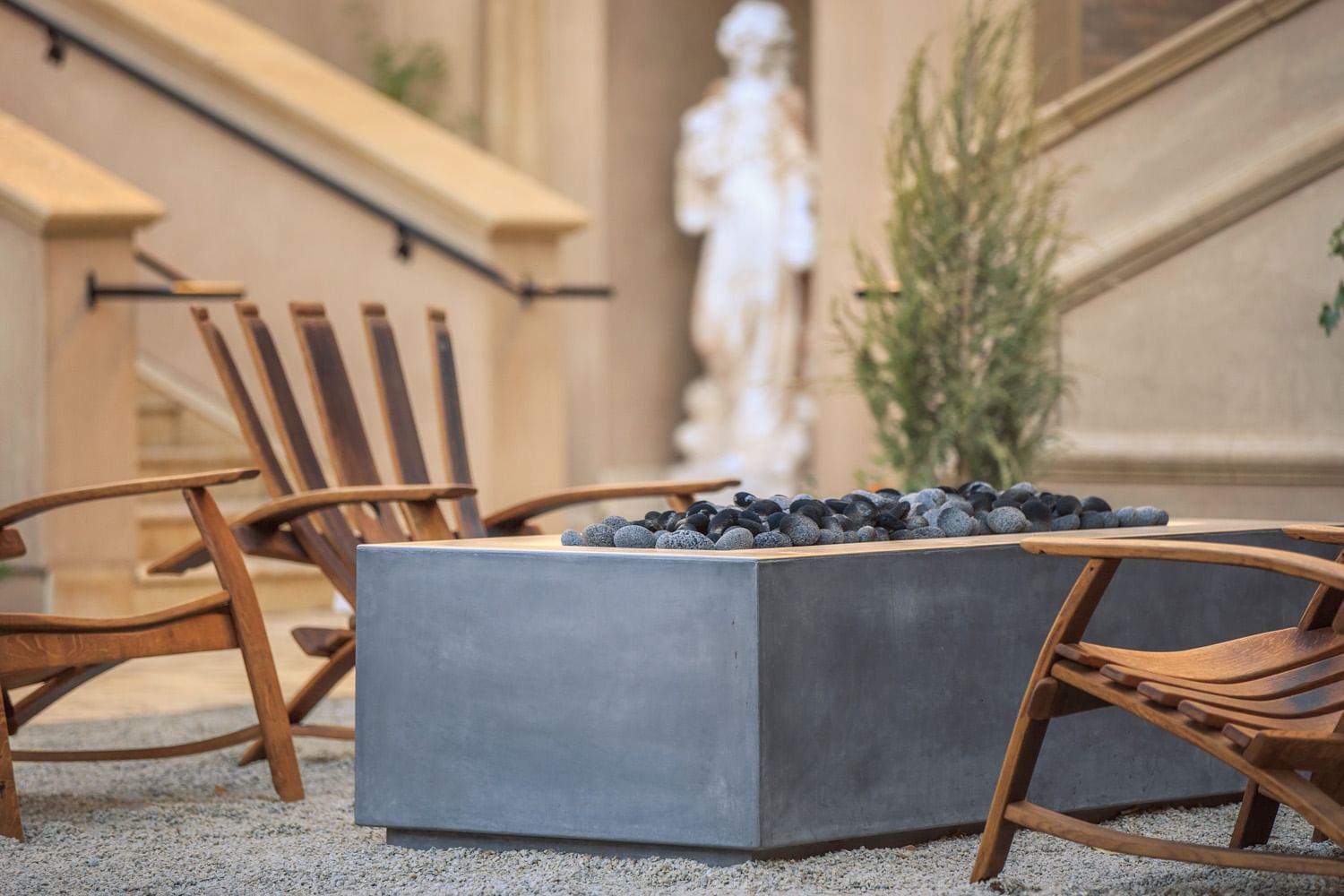 Lorem ipsum Fire pit in the courtyard surrounded by wooden lounge chairs