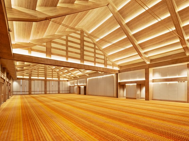Large empty conference hall with wooden ceiling and orange carpeting at Grand Fiesta Americana Sumiya Cuernavaca.