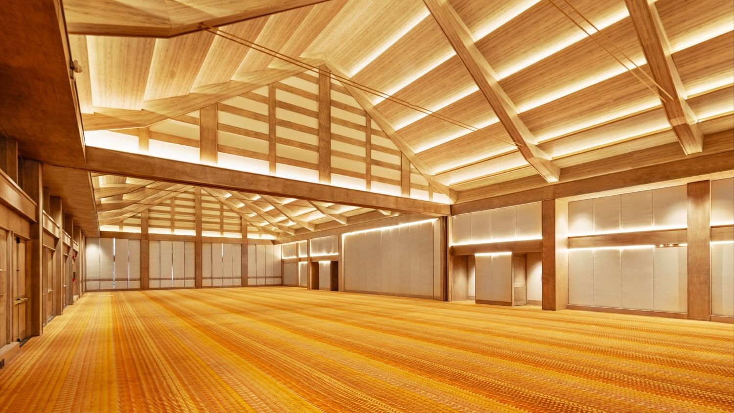 Large empty conference hall with wooden ceiling and orange carpeting at Grand Fiesta Americana Sumiya Cuernavaca.