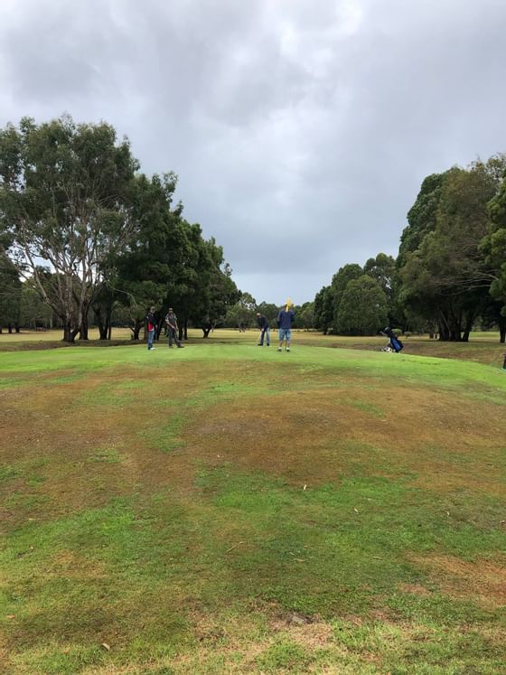 People playing golf at the golf course near Strahan Village